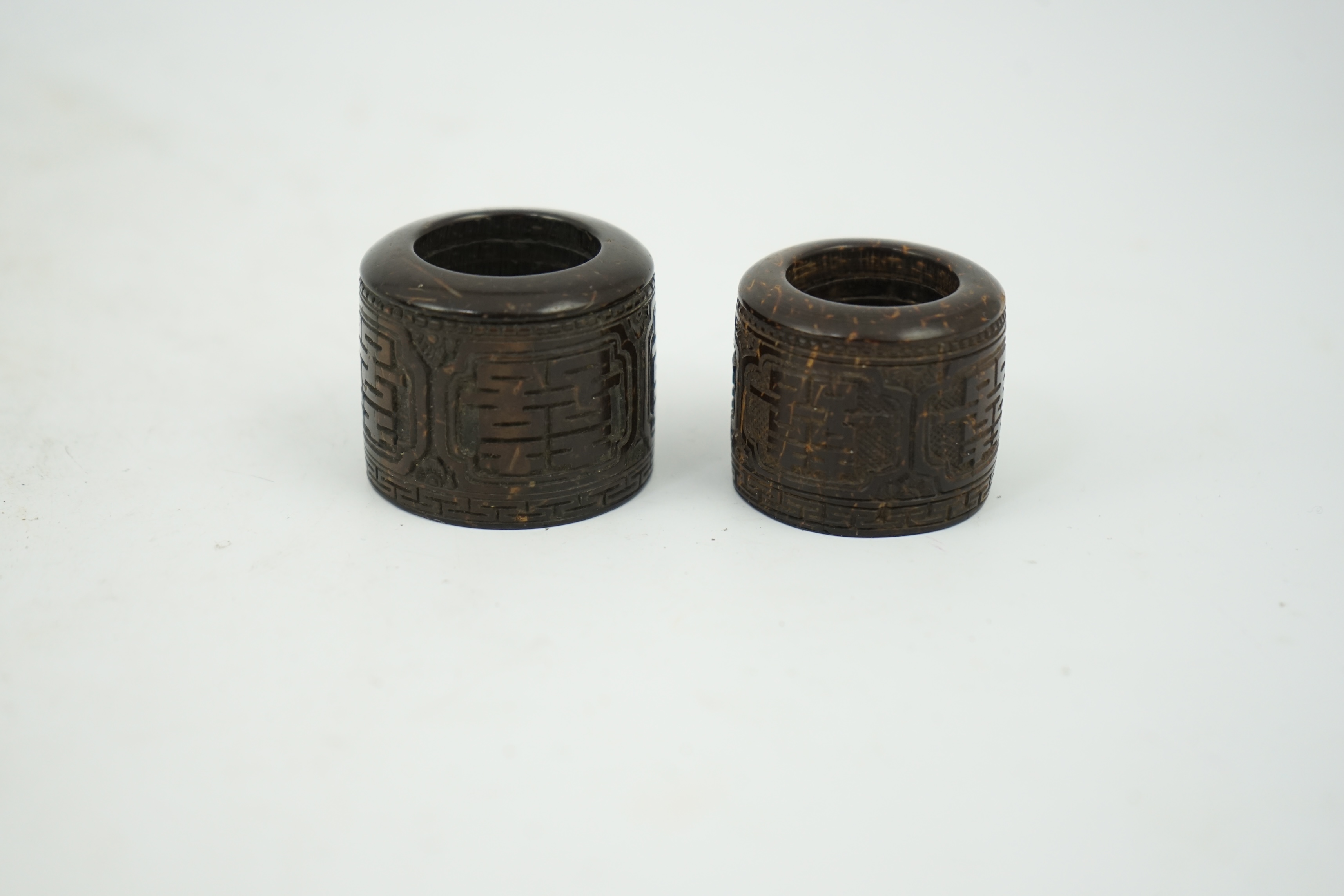 A pair of rare Chinese Straits palm wood archer's thumb rings, 19th century